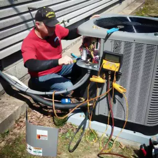  Technician working hard on an air conditioner repair.